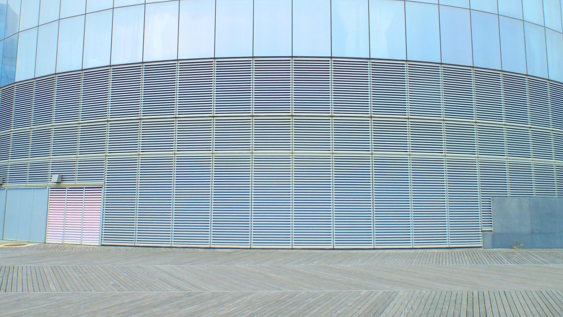modern glass building wall on clear day