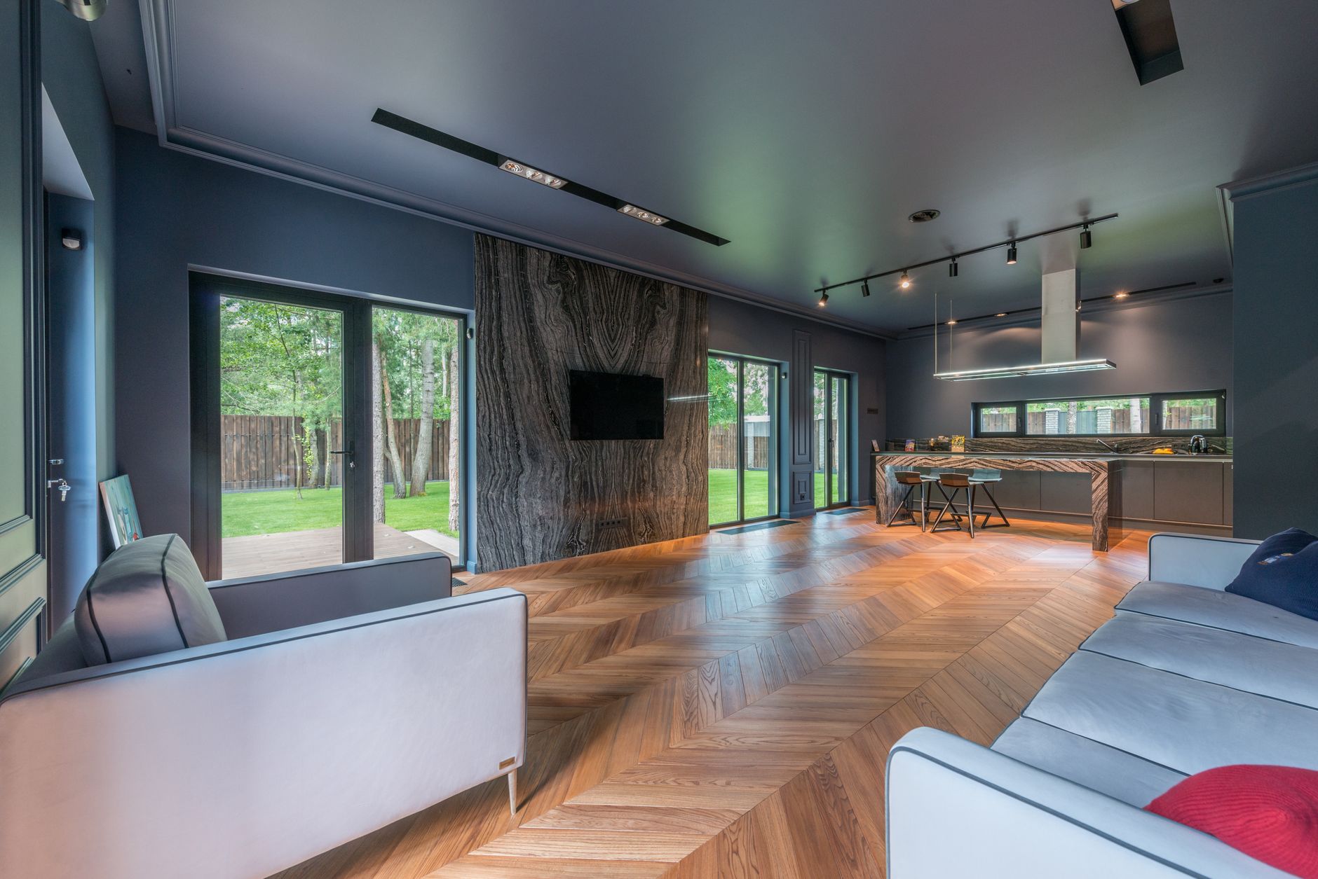 a spacious living room with couch and flat screen television on the wall
