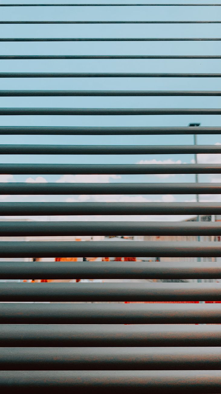city street behind half closed shutters