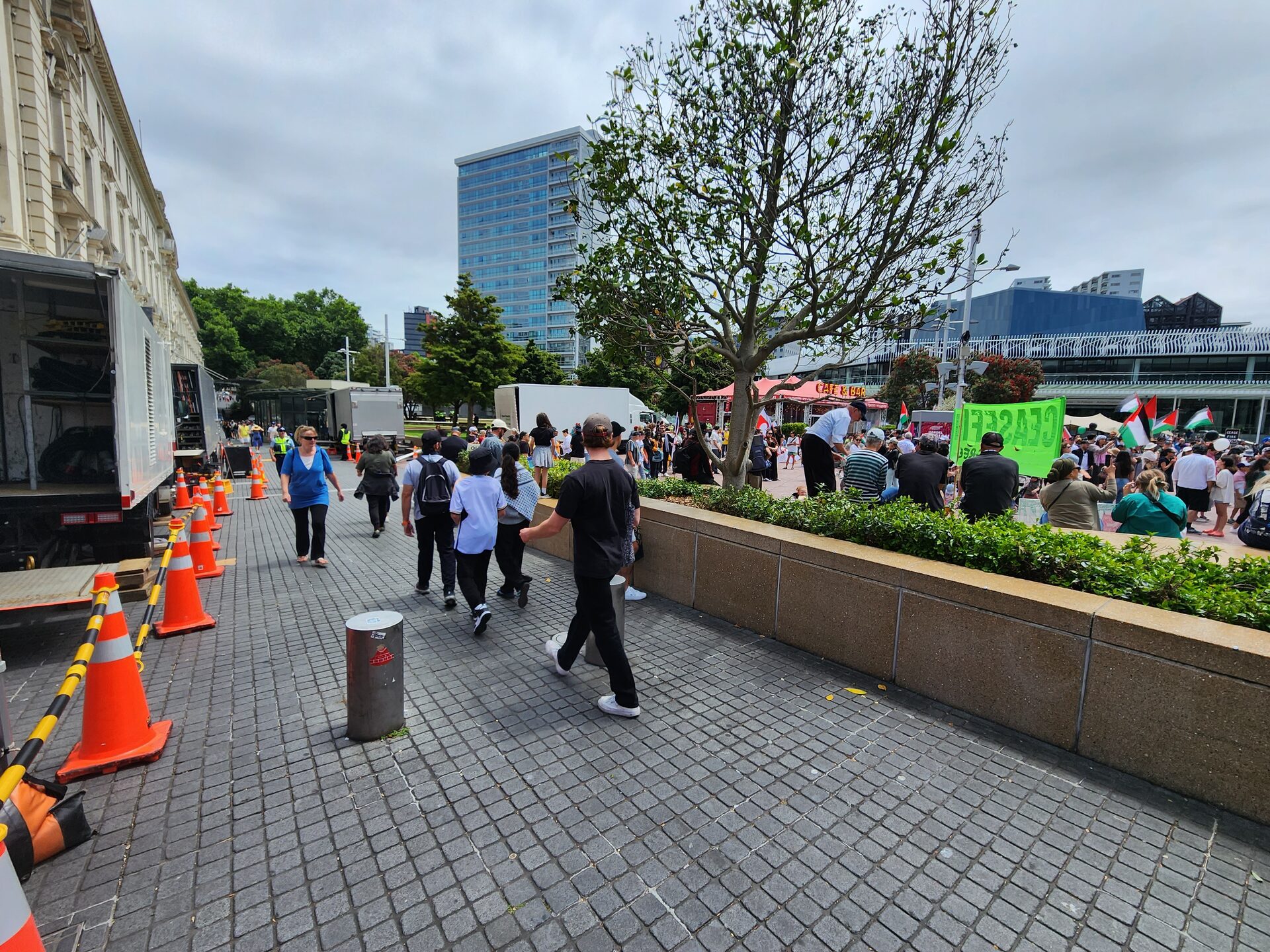 Coned pedestrian route past a film unit on a busy Auckland CBD footpath