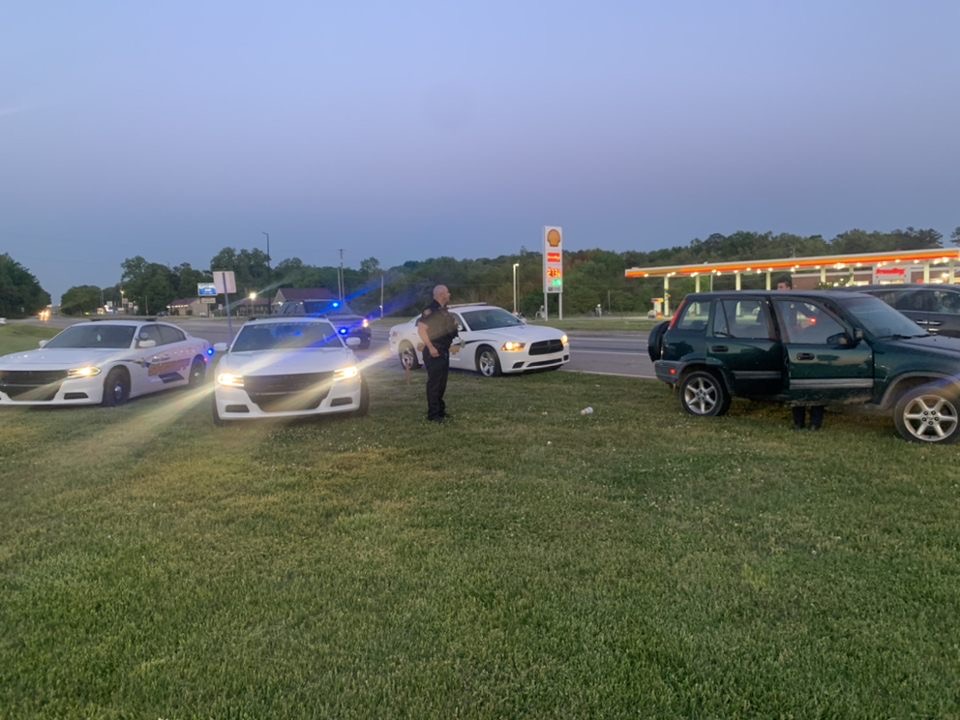 Police vehicles with suspect's car