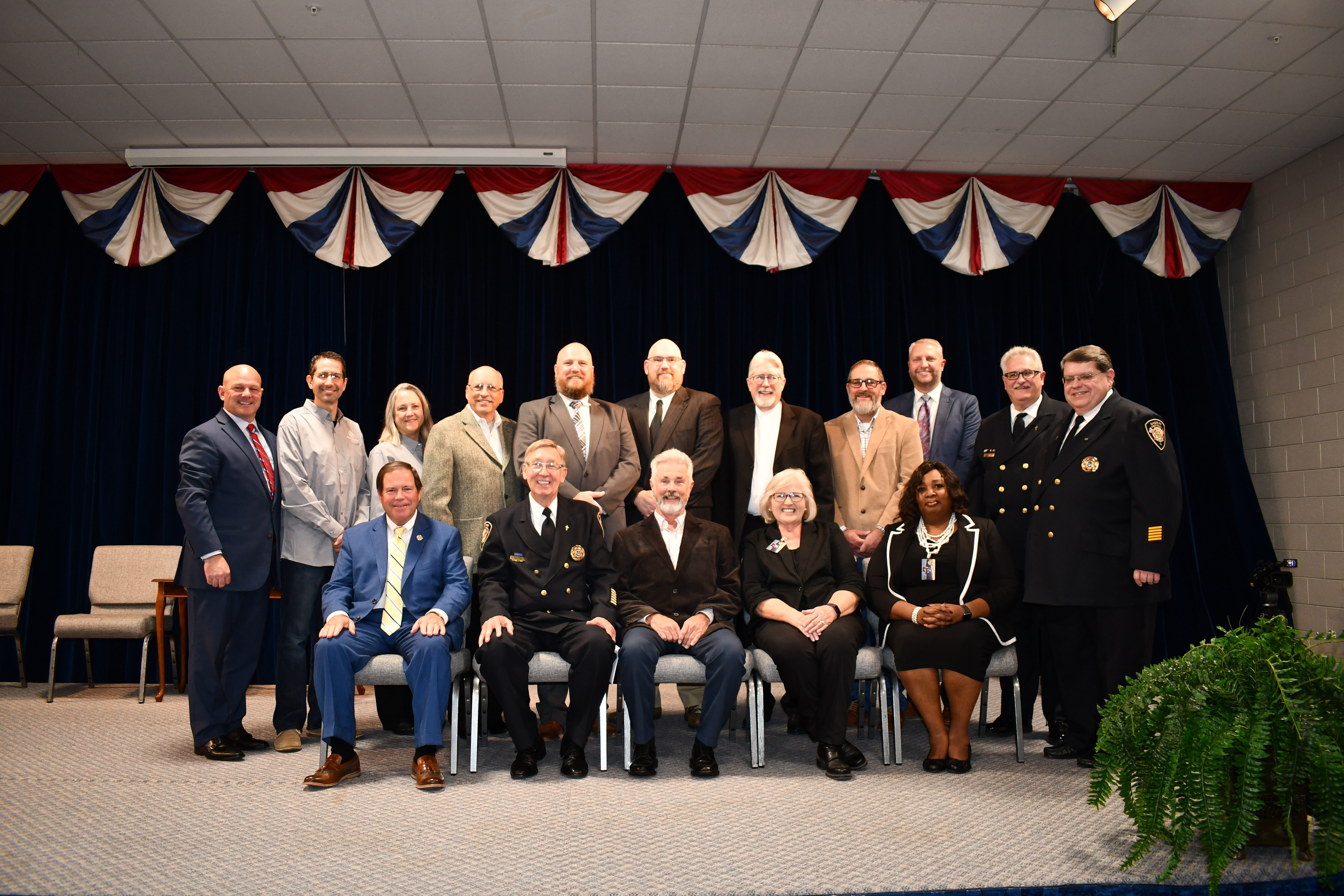 Sheriff with many other individuals posing for camera