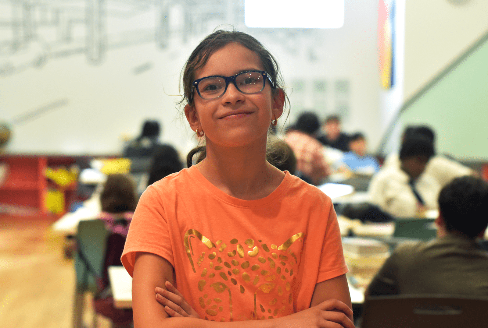 kid in classroom wearing orange shirt
