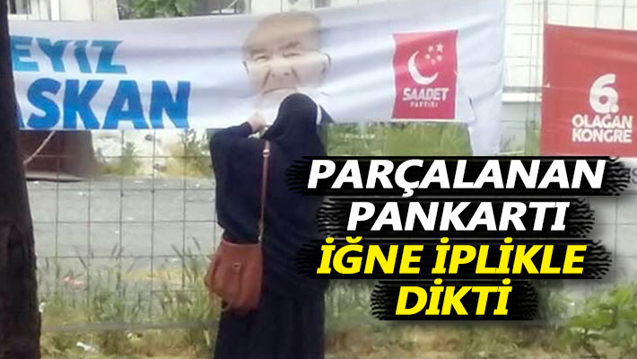 Parçalanan pankartı iğne iplikle dikti