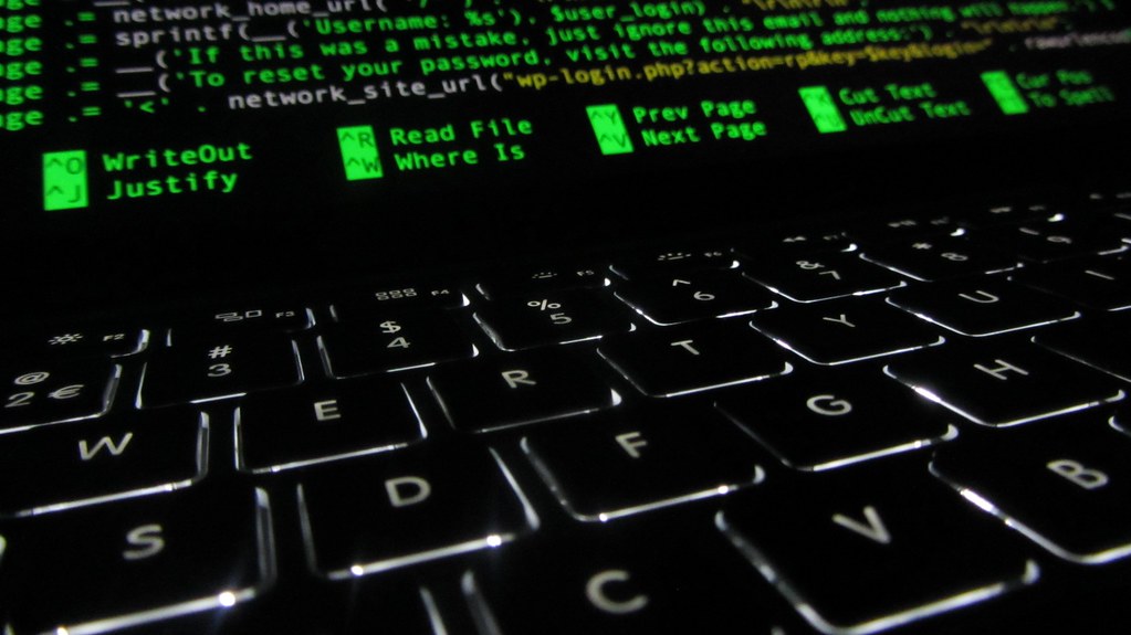 Developer looking at source code on a screen, illustrating GitHub Copilot billing and coding costs