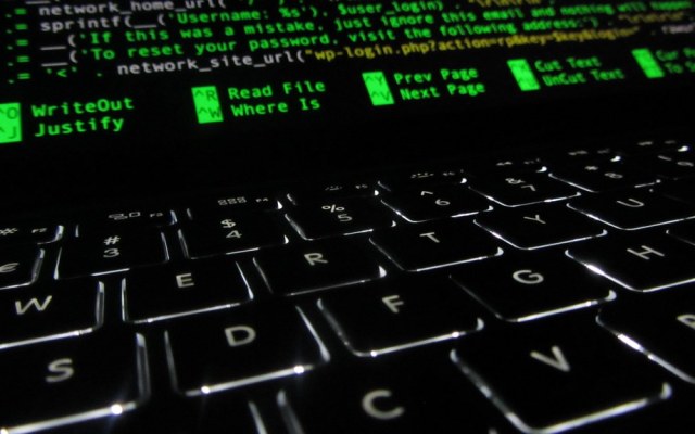 Developer looking at source code on a screen, illustrating GitHub Copilot billing and coding costs