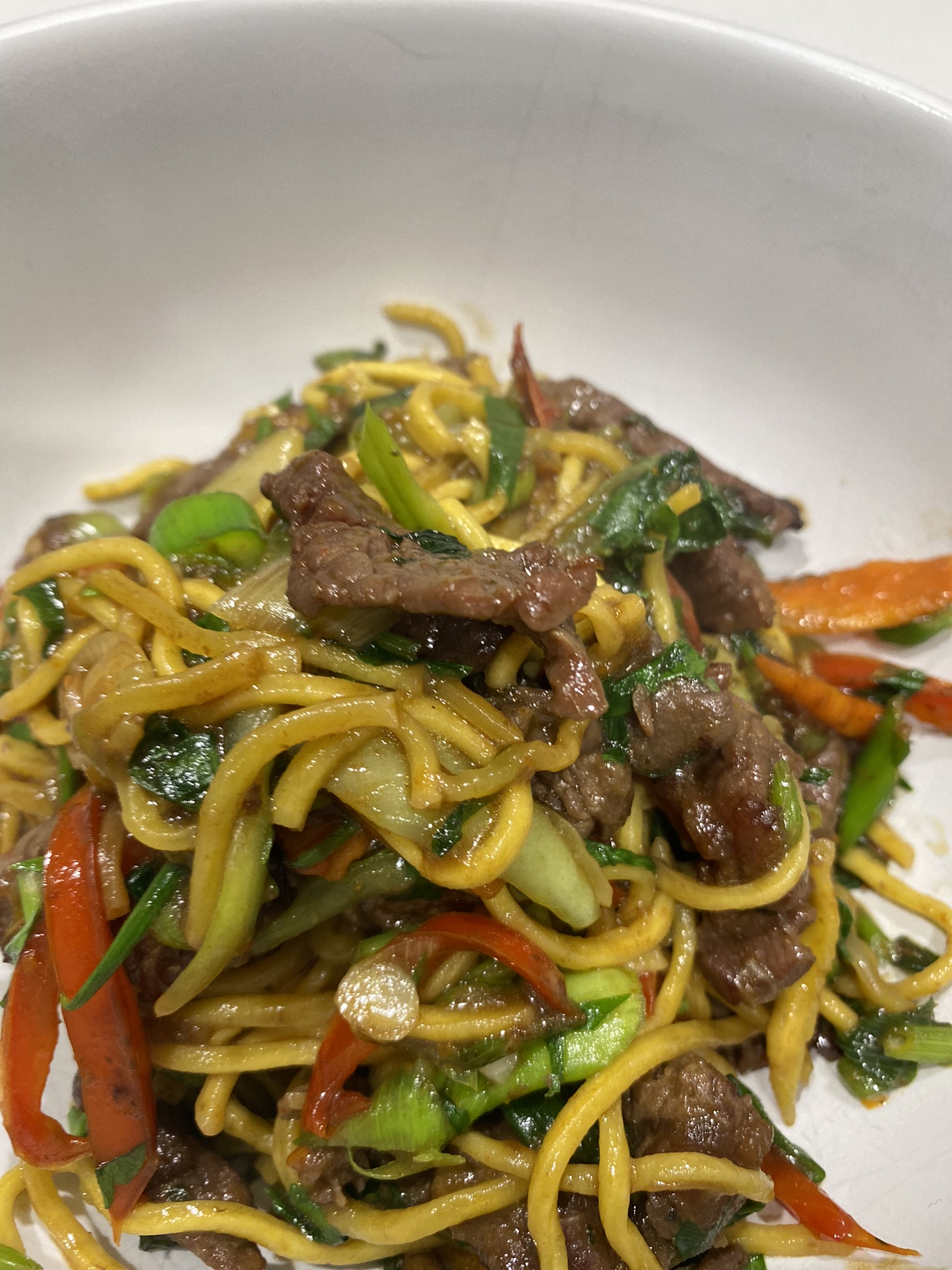 Stir-fry beef noodles is a delicious and quick Asian dish that features tender slices of beef, stir-fried with colourful vegetables such as bell peppers, carrots, and Bok choy. The dish is seasoned with a flavourful combination of soy sauce, ginger, and garlic, providing a savory and slightly sweet taste.