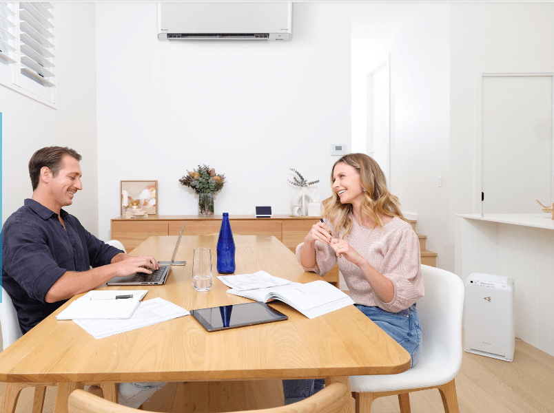 Man and Woman in Dining-Room with daikin white split system in gippland