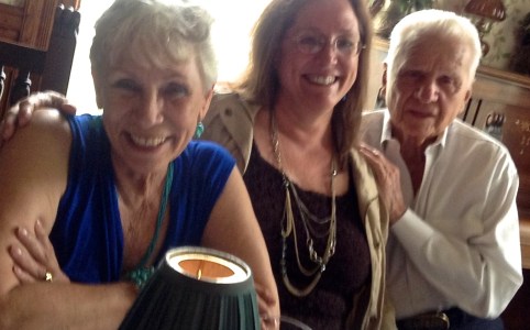 Author K.P. Davis with her mother and father who inspired her chapbook, A Thin Line. Three people sit smiling for a picture.
