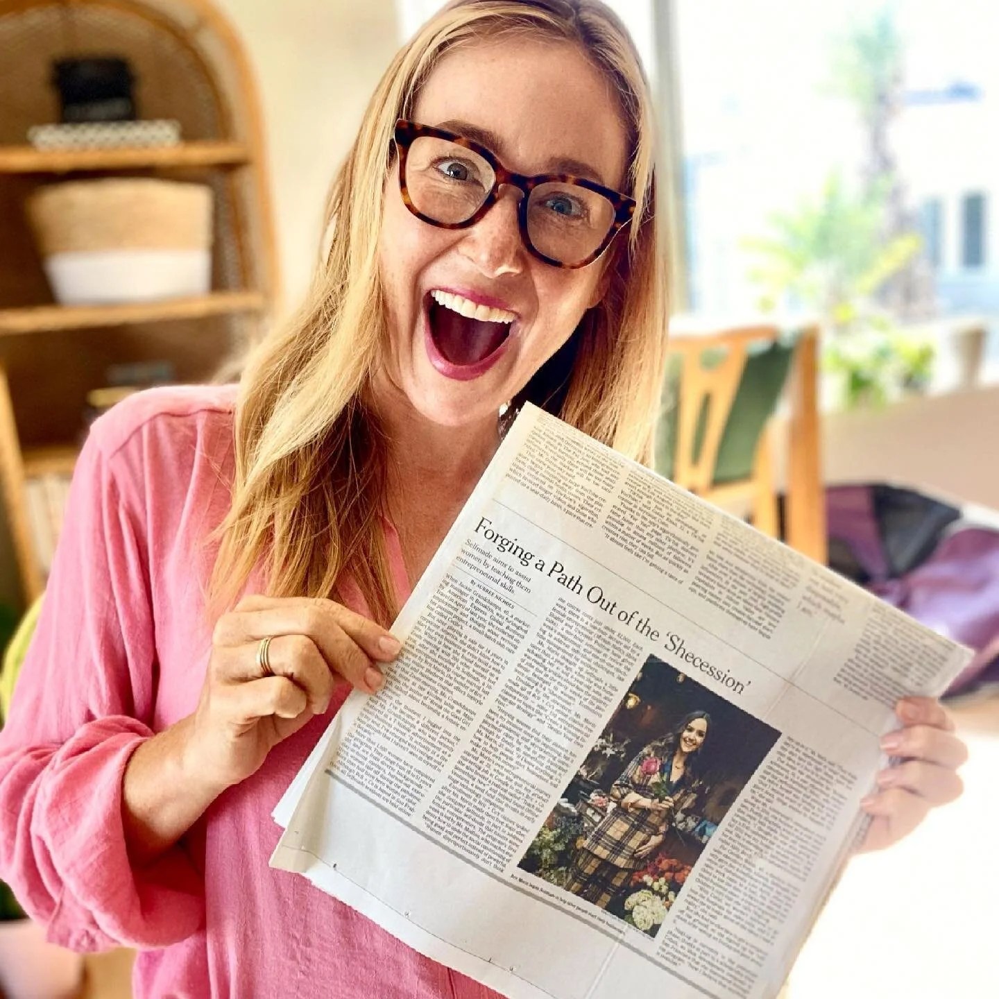 Aubree holding a newspaper she is featured in