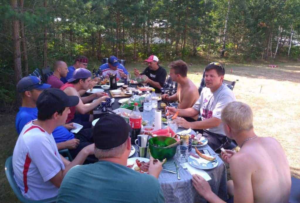 Photo of Chaska Kubb sharing a meal with locals.