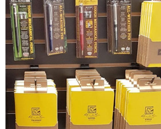 Stationery display with pens and notebooks.
