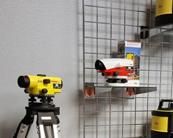 Surveying equipment on display, including tripods.