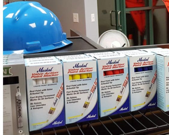 Paint markers and blue hard hat displayed.