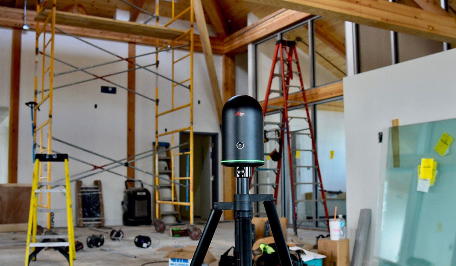 Construction site with laser scanner and scaffolding.