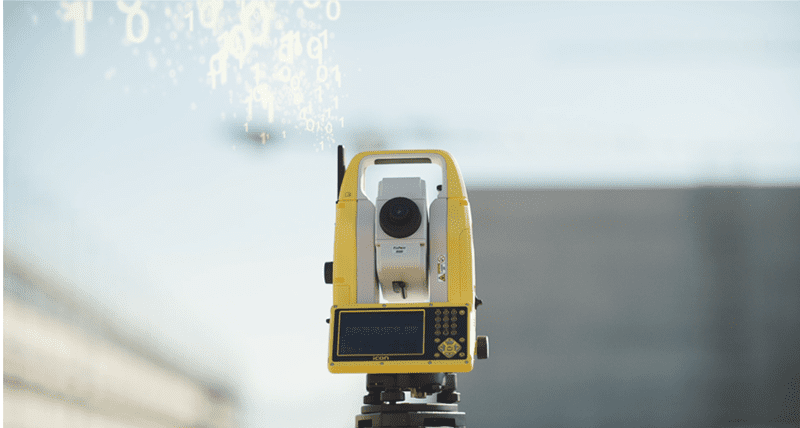 Yellow total station surveying equipment.
