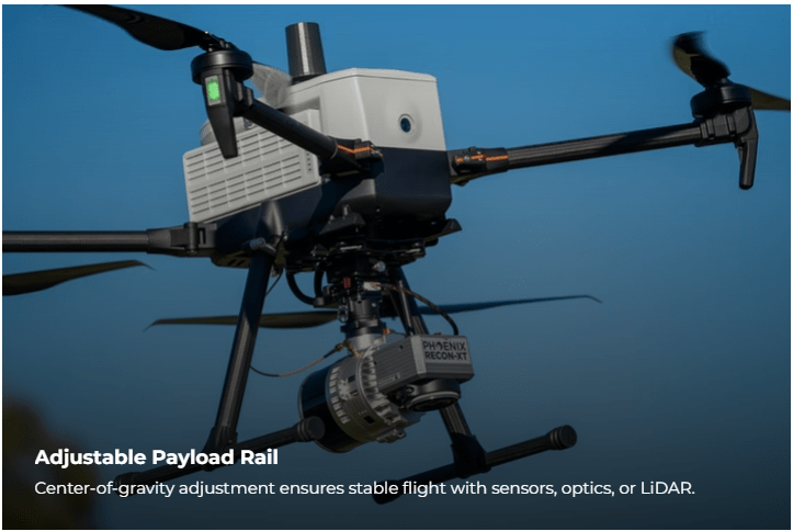Drone with adjustable payload rail in flight.