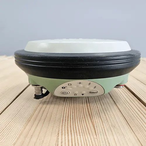 Here's an alt tag for the image: Green and black surveying receiver.