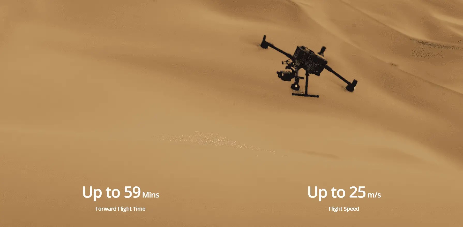 Drone flying over desert sand dunes.
