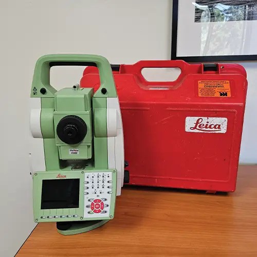 Leica surveying equipment with red carrying case.