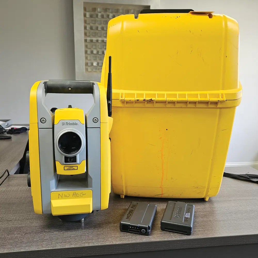 Yellow surveying equipment with protective case.