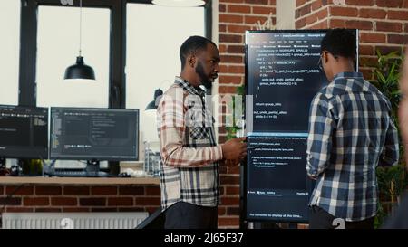 System Engineers Comparing Source Code On Wall Screen Tv Analyzing Errors Using Digital Tablet - Space Patterns - Stunning Full HD Collection