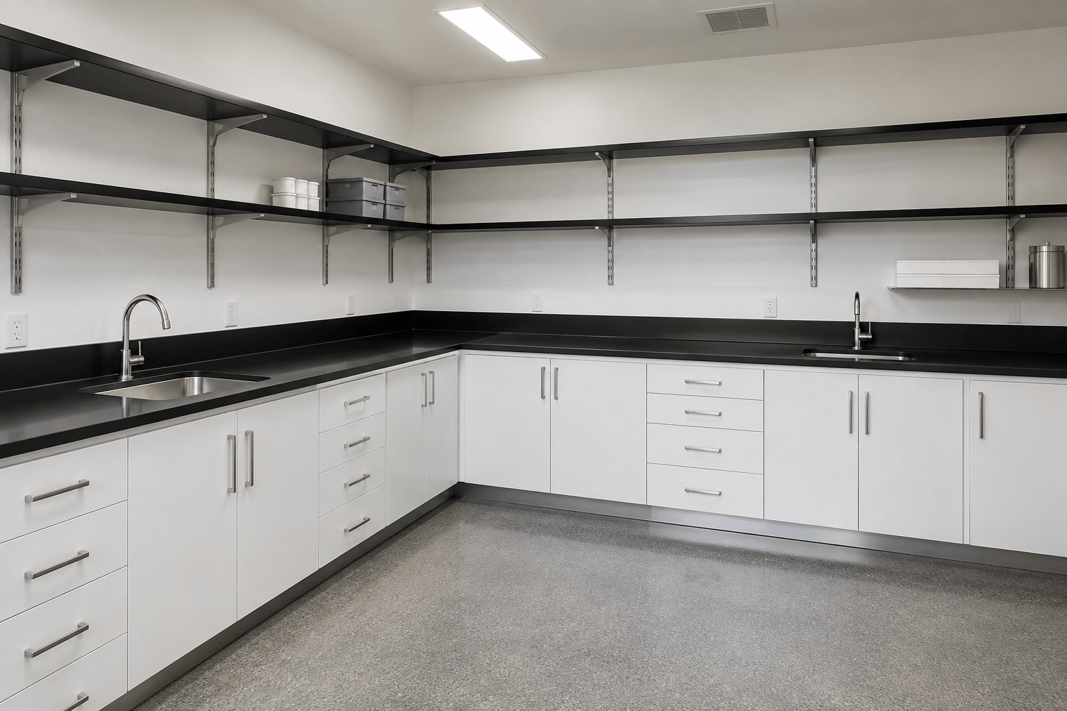 Workroom with white painted steel cabinetry, black epoxy resin countertops and black epoxy resin wall shelves on metal brackets