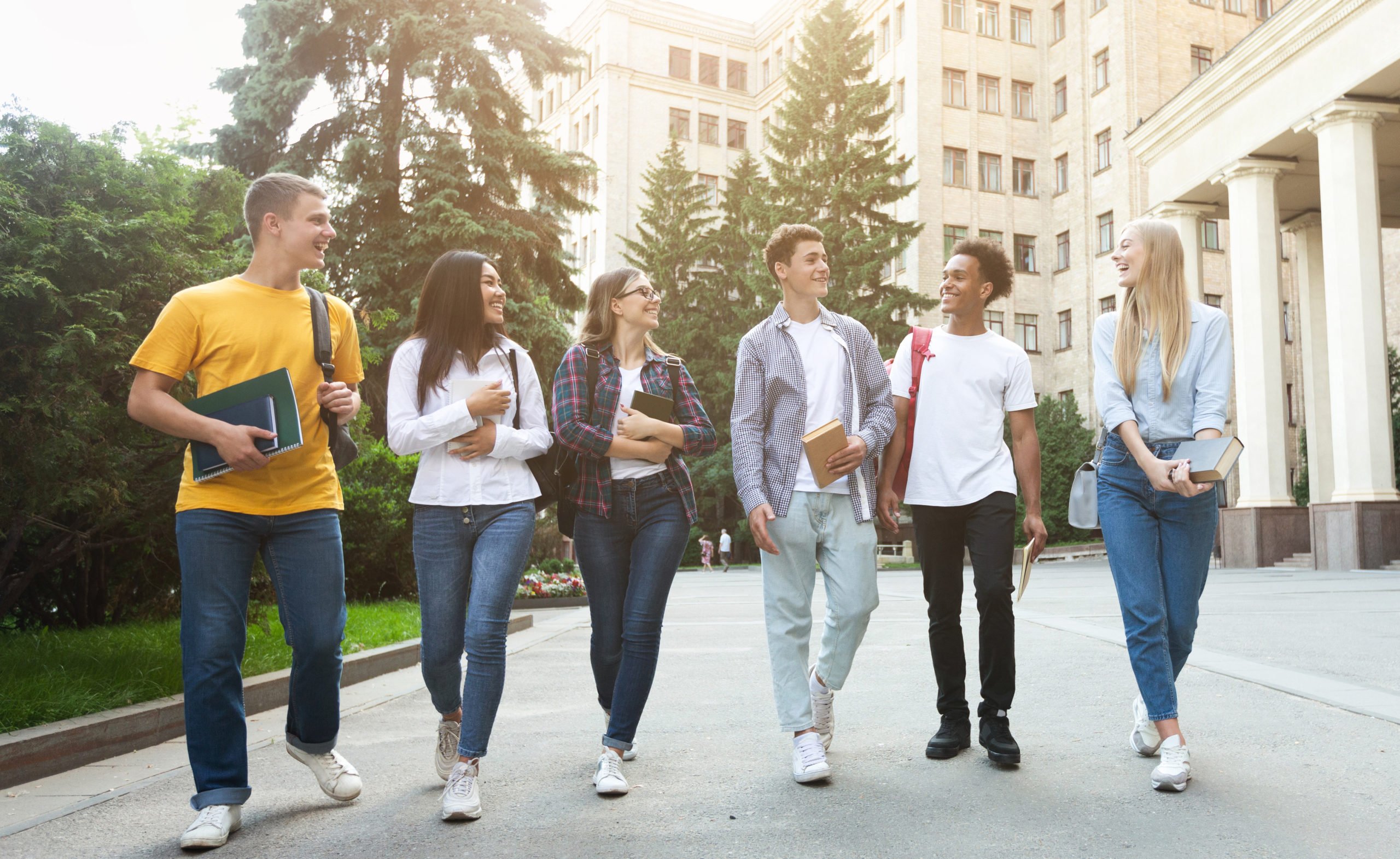 Students walking outside the college building and talking