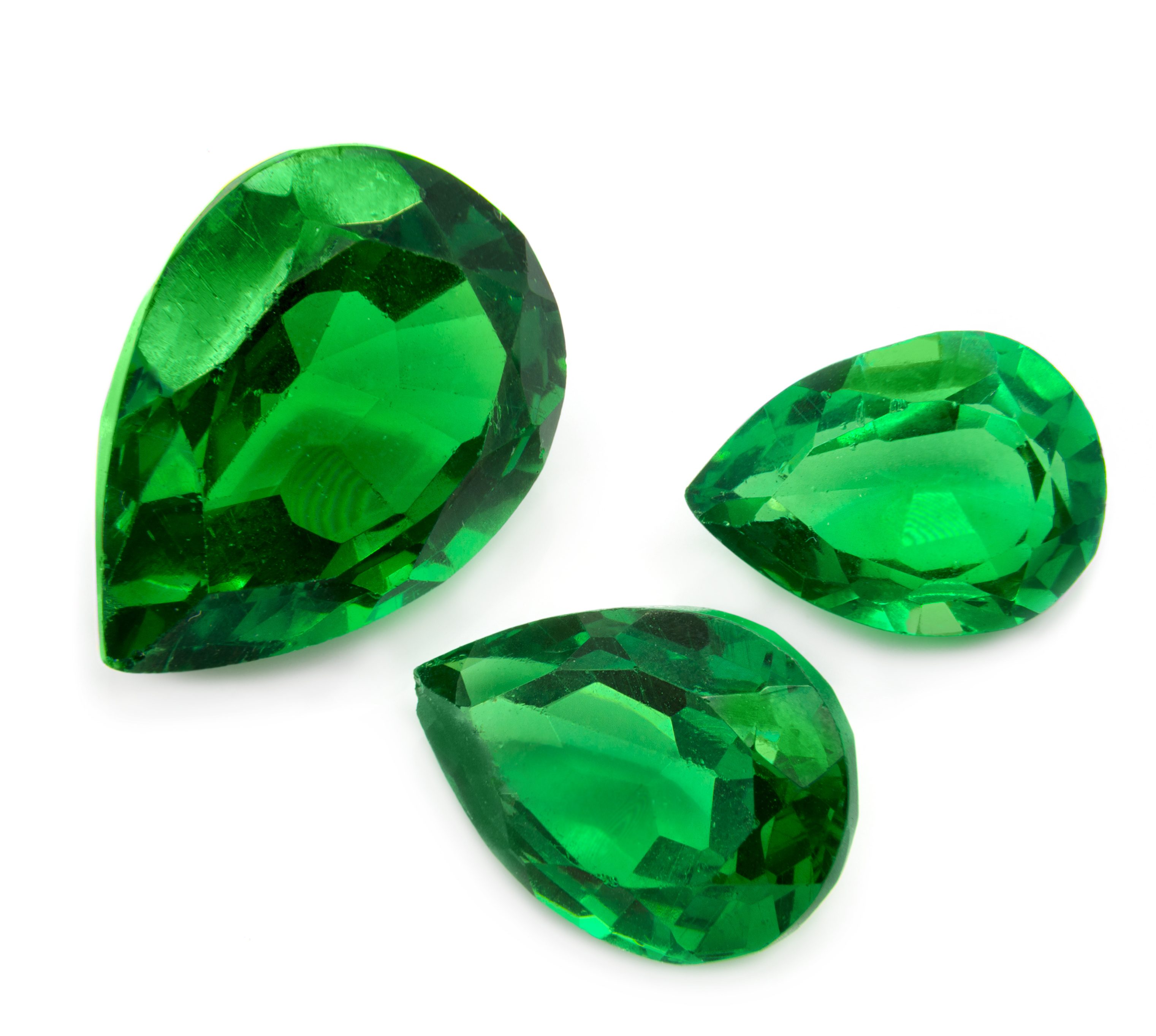 Green emeralds on a white background. Precious gems.