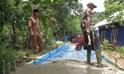 Peratin Pekon Asahan Way Sindi, Ismadi, meninjau pembangunan jalan. Foto: Riski Saputra