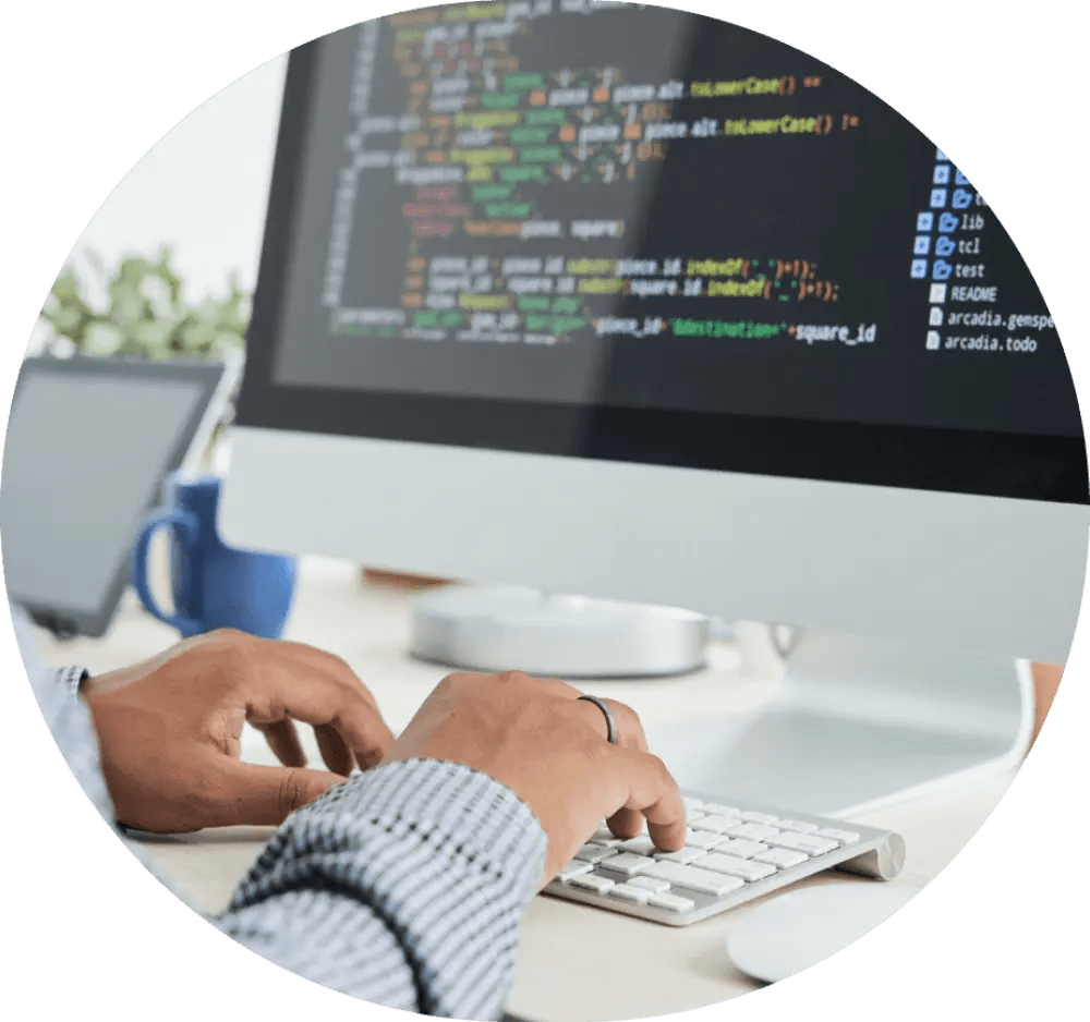 Person coding on an iMac.