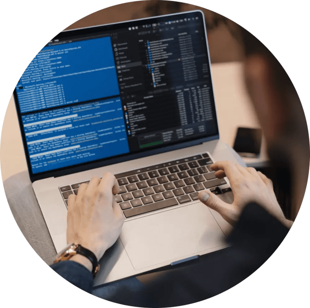 Person coding on a laptop.