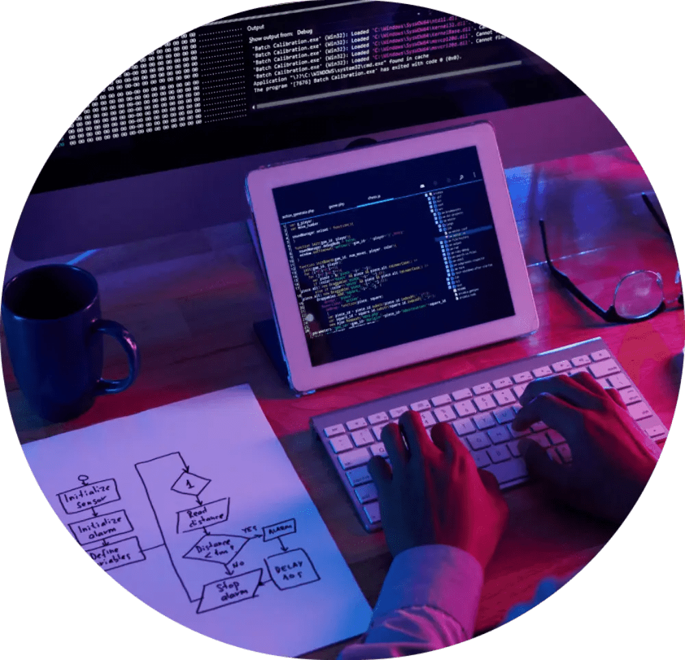 Person coding with tablet and laptop.