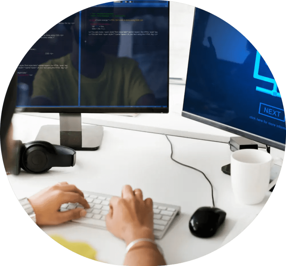 Person coding on dual monitors