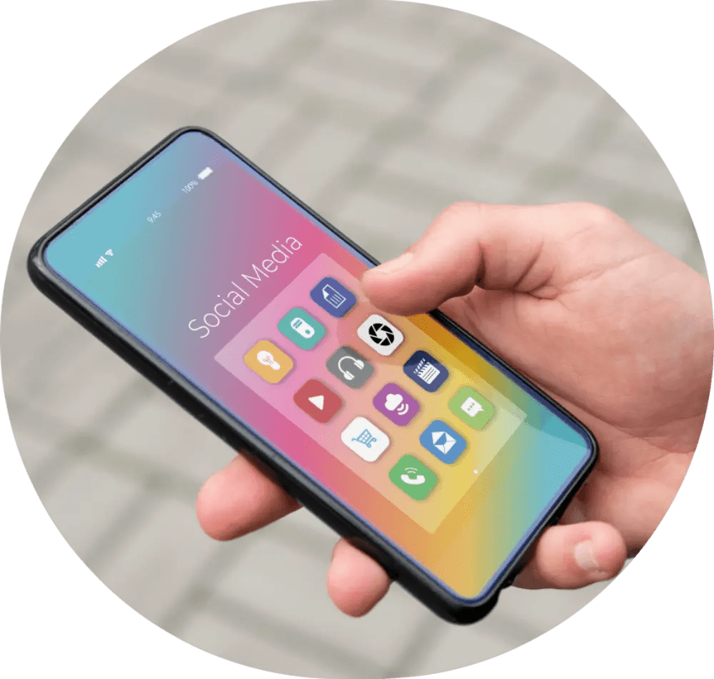Hand holding phone with social media apps