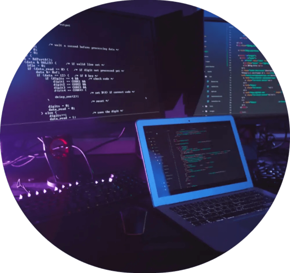 Multiple monitors displaying code.