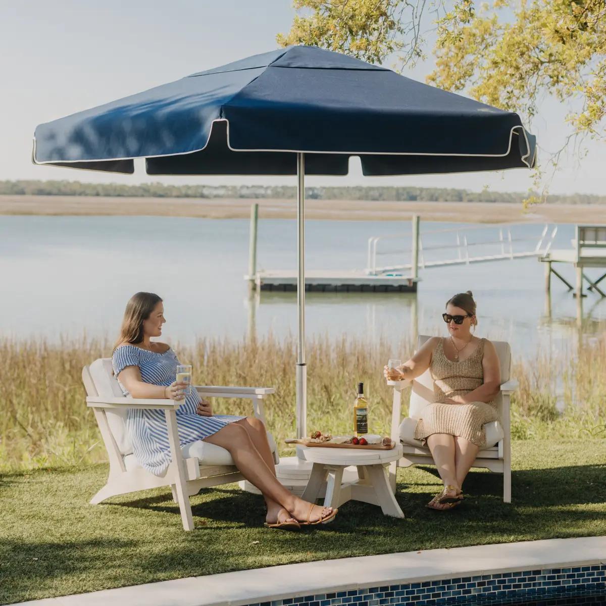 Palmetto Umbrella with a Round Anchor Base, Bourbon Side Table and Bourbon Chairs built for outdoor evening drinks.