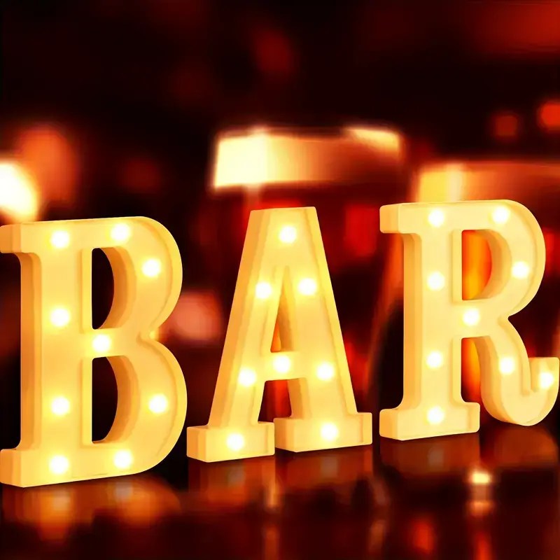 Glowing marquee letters spelling BAR in warm ambient lighting, ideal for parties, bars, or home decor.