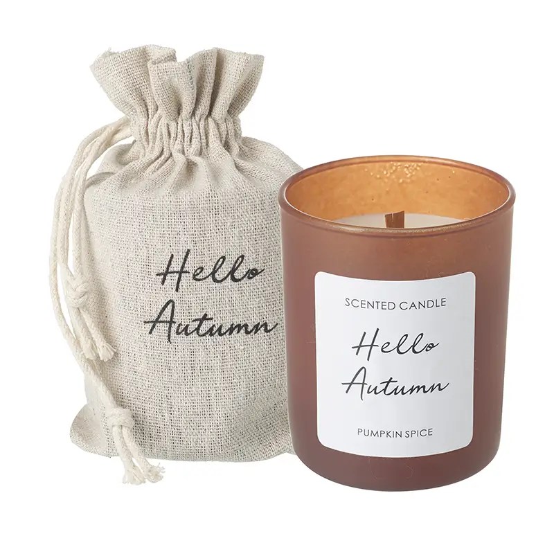 Pumpkin spice scented candle in amber jar with Hello Autumn linen bag