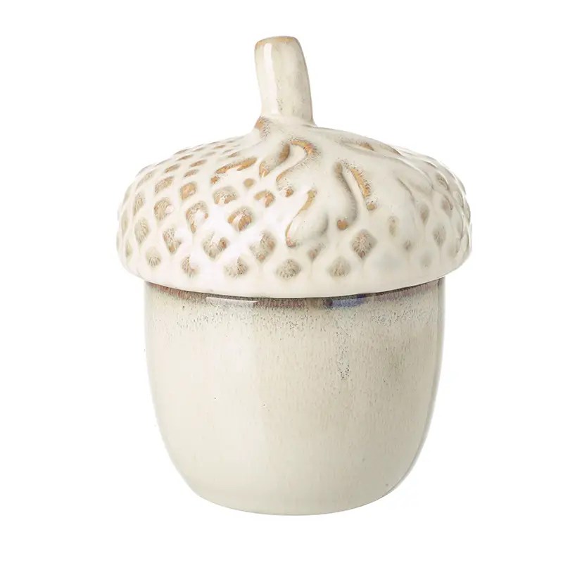 Glossy cream ceramic acorn ornament with textured top, autumn display