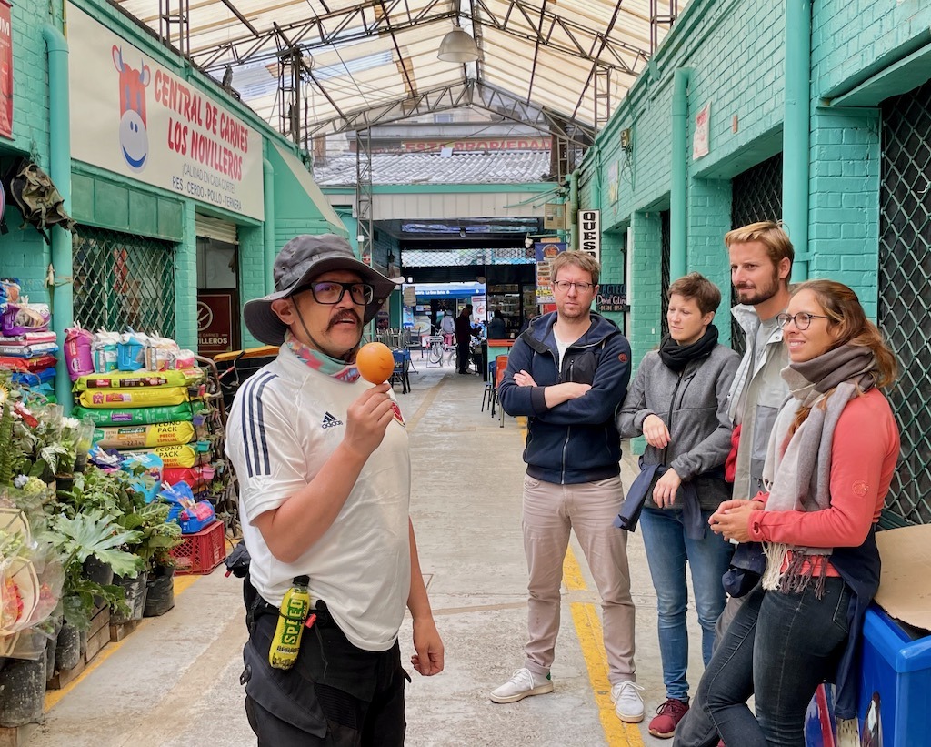 Trying some local fruits in a downtown market