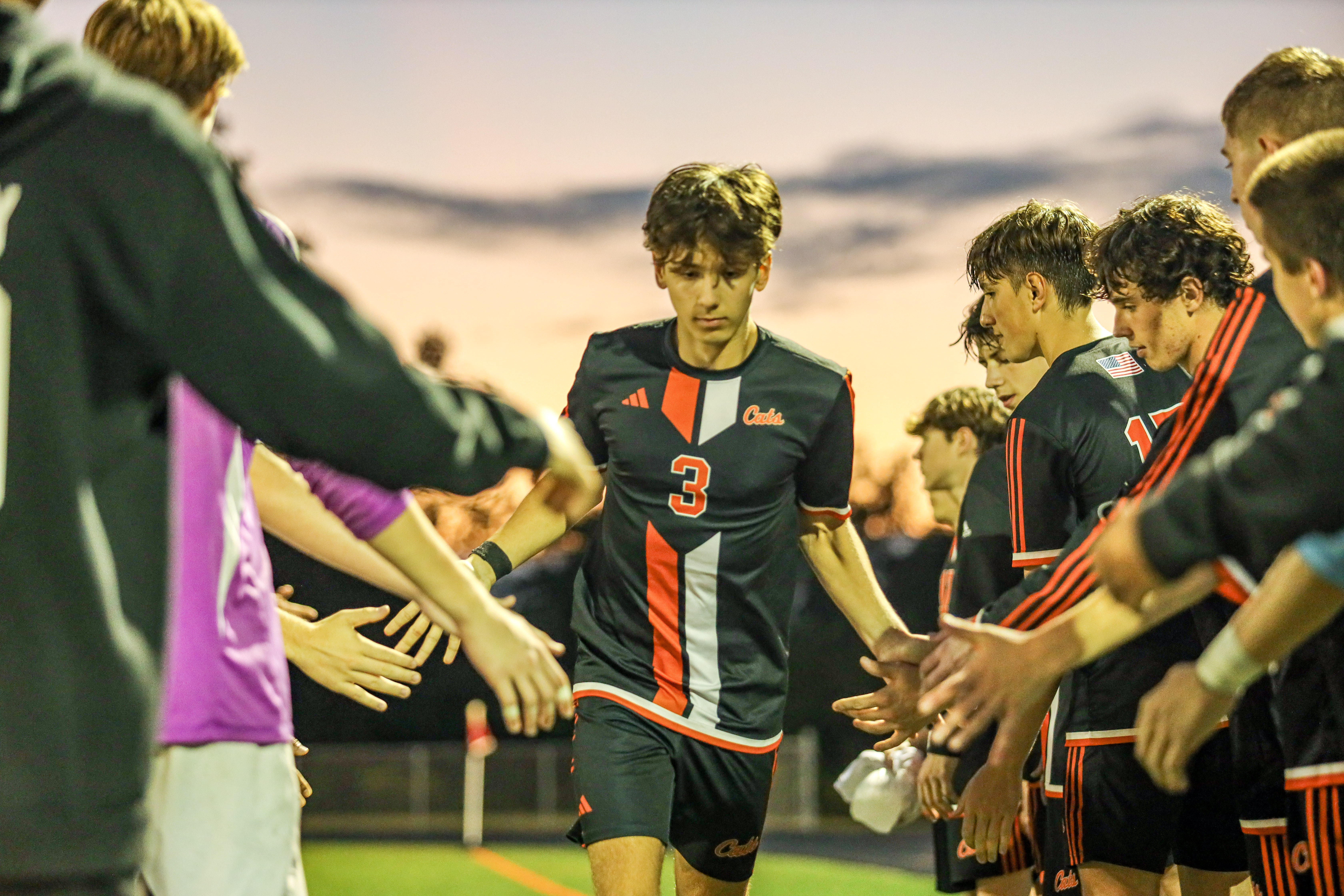 Senior captain Jacob Stephenson walking through a tunnel formed by his Greater Latrobe teammates