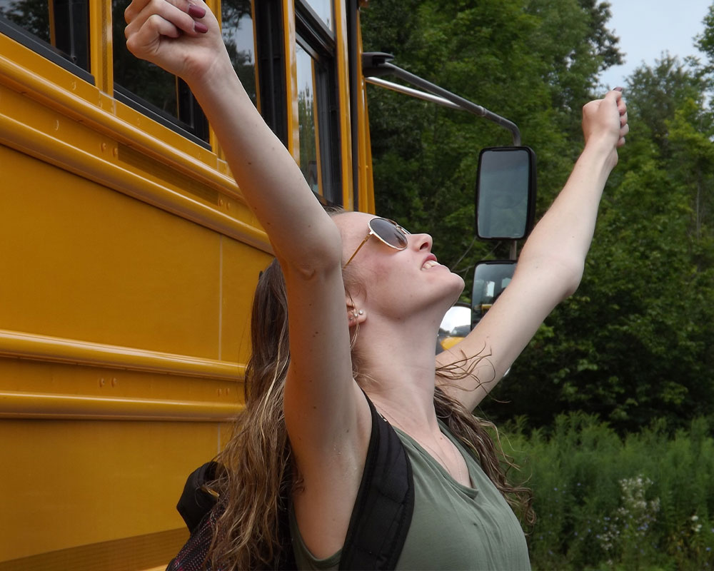 excited high school girl with her arms up