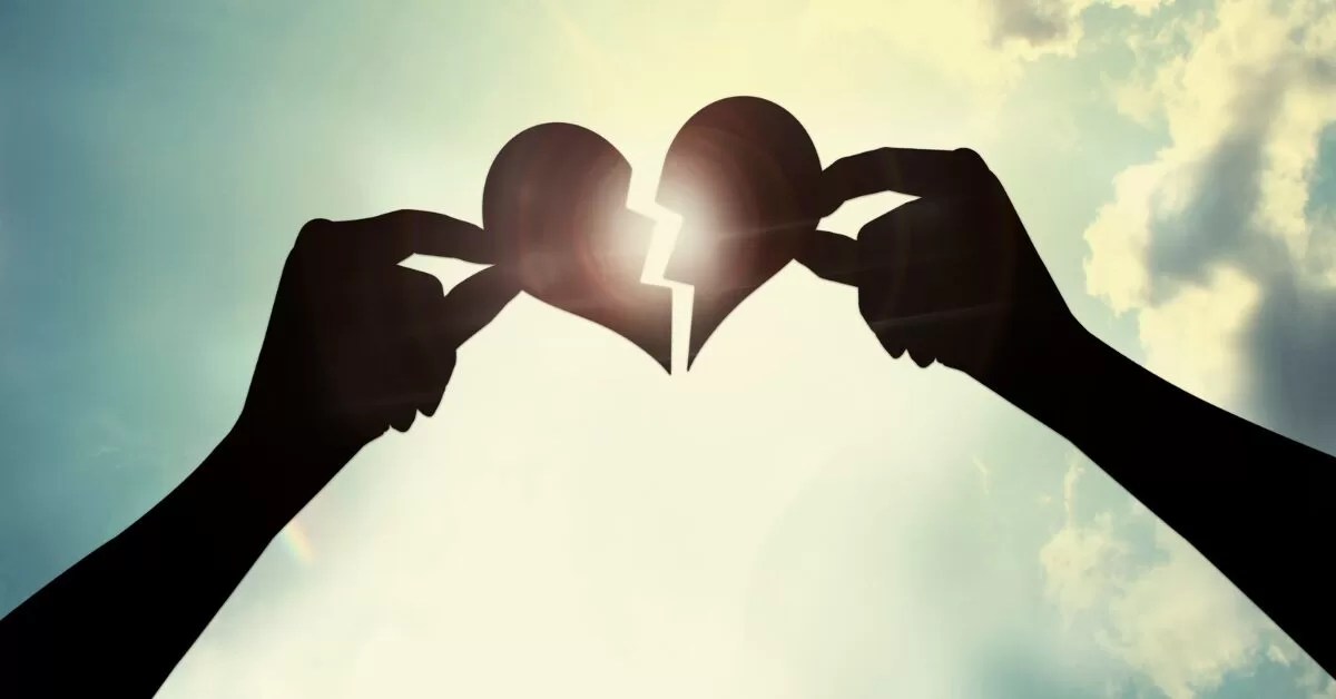 hands holding a broken heart