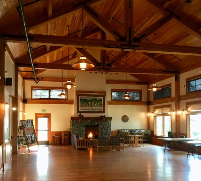 The event space at Cama Center features a stone fireplace, lofty ceilings, and a display of quilts made by local volunteers. (Mr. Adventure photo)
