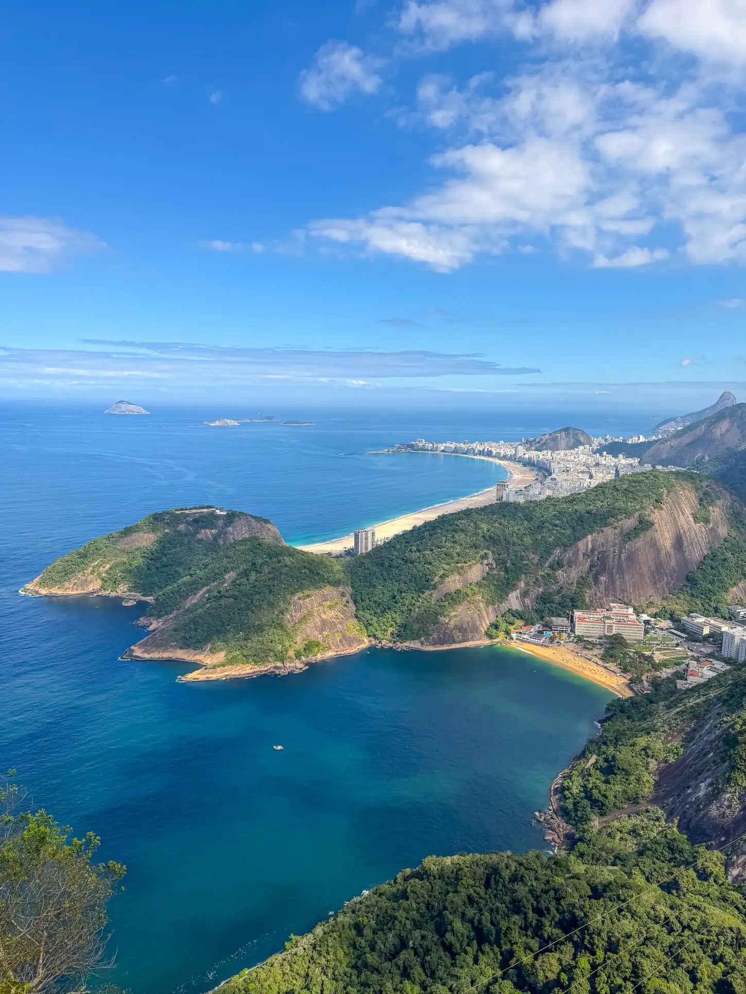 Scenic view of Rio de Janeiro's coastline and mountains under a blue sky - staring point for where to go in Brazil!