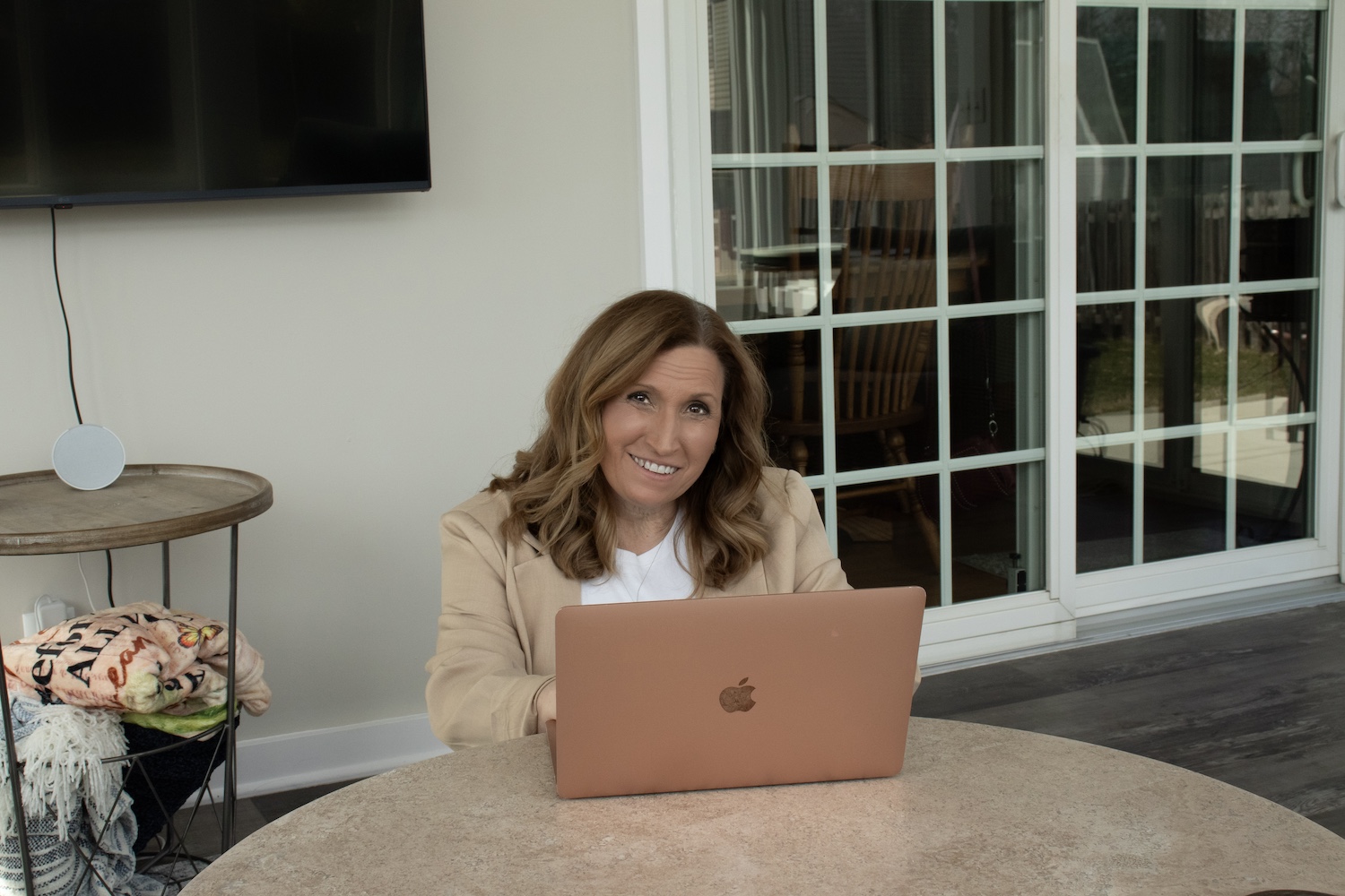 me on the porch sitting a low table looking over my laptop at the camera