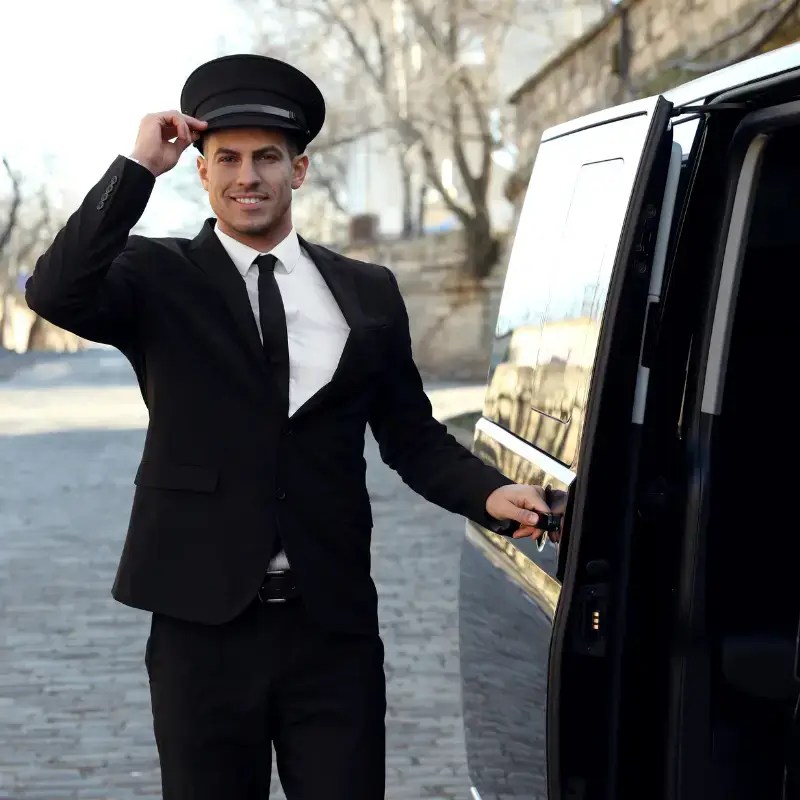 A chauffeur opening the door of a vehicle