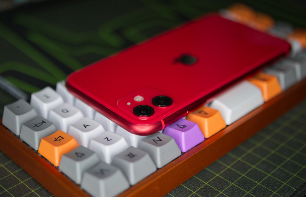 iPhone 11 on keyboard. Product Red version