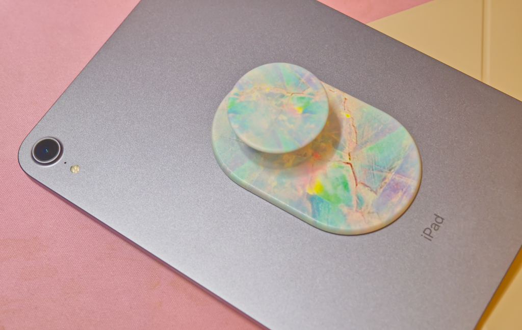 An iPad mini with a Pop Socket on the back of it